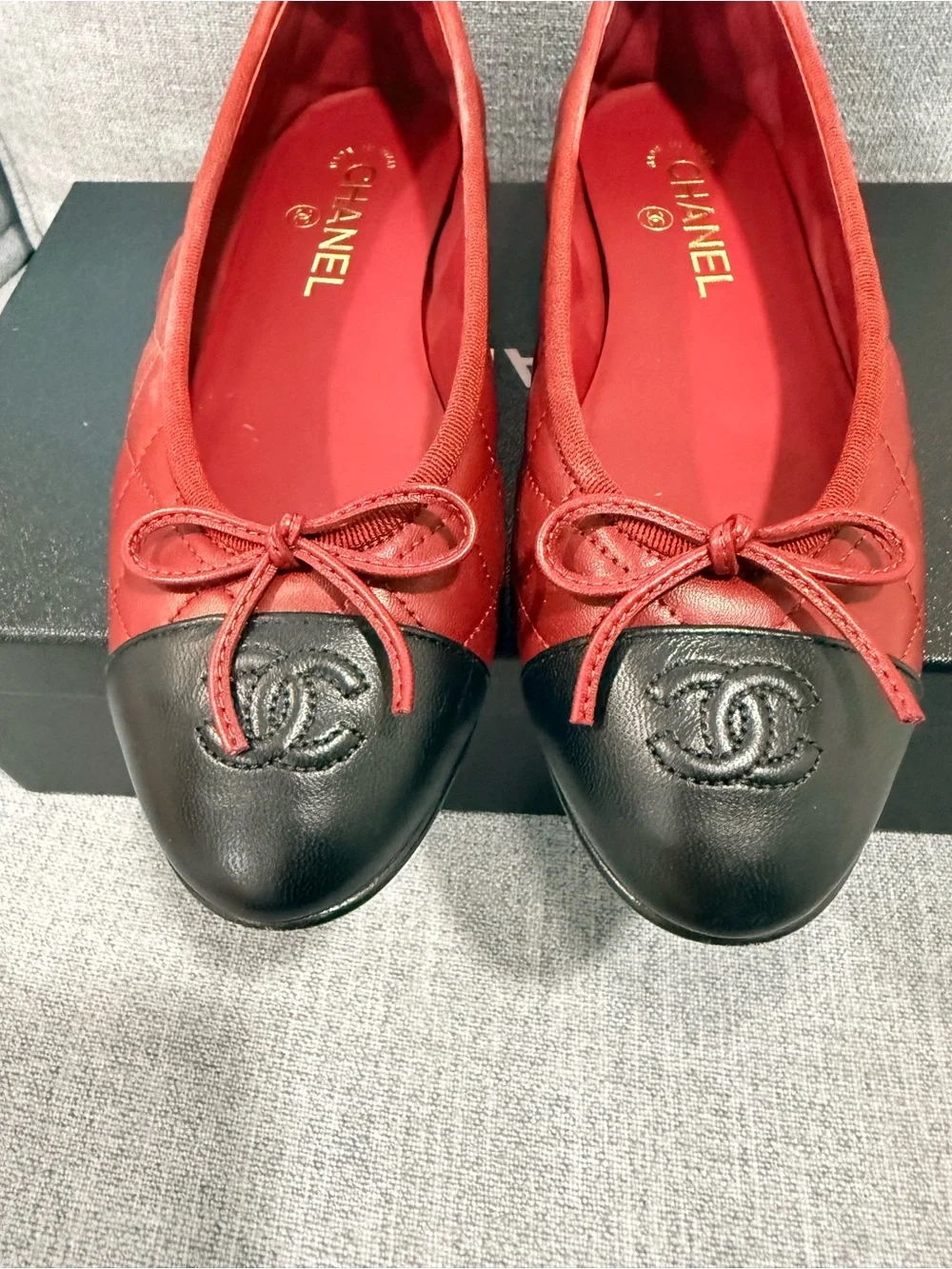 CHANEL Red Leather Ballet Flats with Black Cap Toe